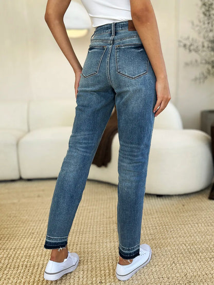 Judy Blue full-size mid-rise rigid jeans with magic release hem, featuring classic denim fabric and a stylish fit.