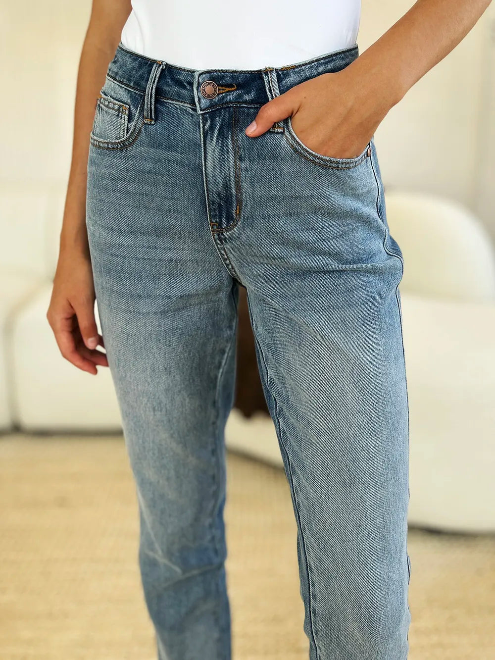 Judy Blue full size mid-rise rigid jeans with magic release hem, shown in a medium wash with classic five-pocket design.