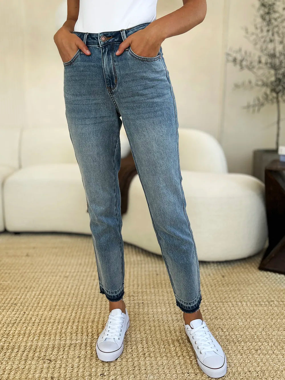 Mid-rise Judy Blue rigid jeans with magic release hem, full size, trendy denim pants by Trendsi shown on model.