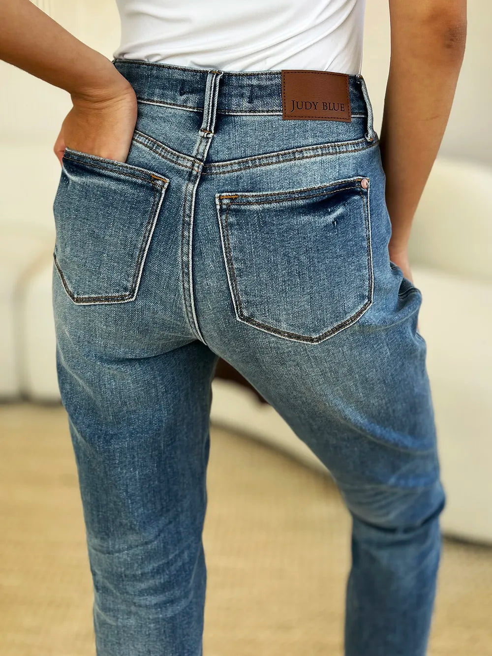 Full size Judy Blue mid-rise rigid jeans with magic release hem, featuring classic denim look and stylish distressed details.