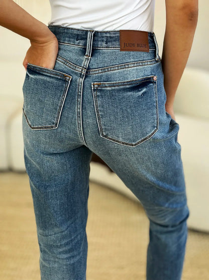 Full size Judy Blue mid-rise rigid jeans with magic release hem, featuring classic denim look and stylish distressed details.