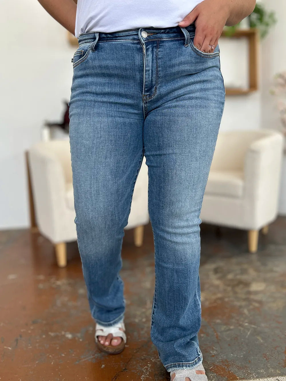 Medium wash Judy Blue full-size mid-rise waist straight jeans displayed on a model, showcasing classic denim style and fit.
