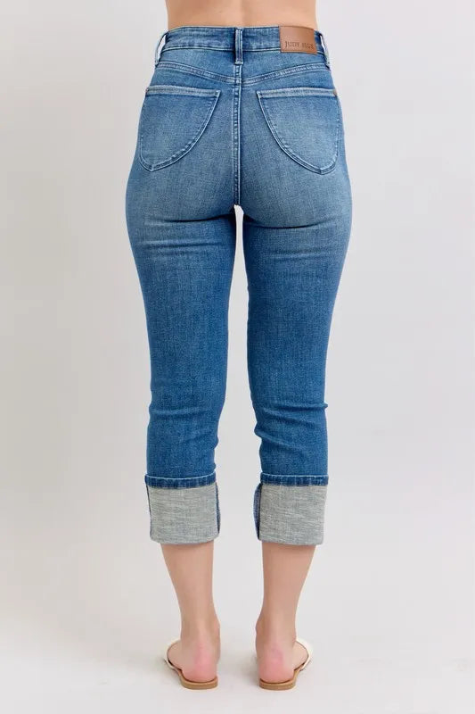 Trendsi Judy Blue plus size full-length skinny cuff capris jeans with pockets, denim fabric, and a fitted silhouette.