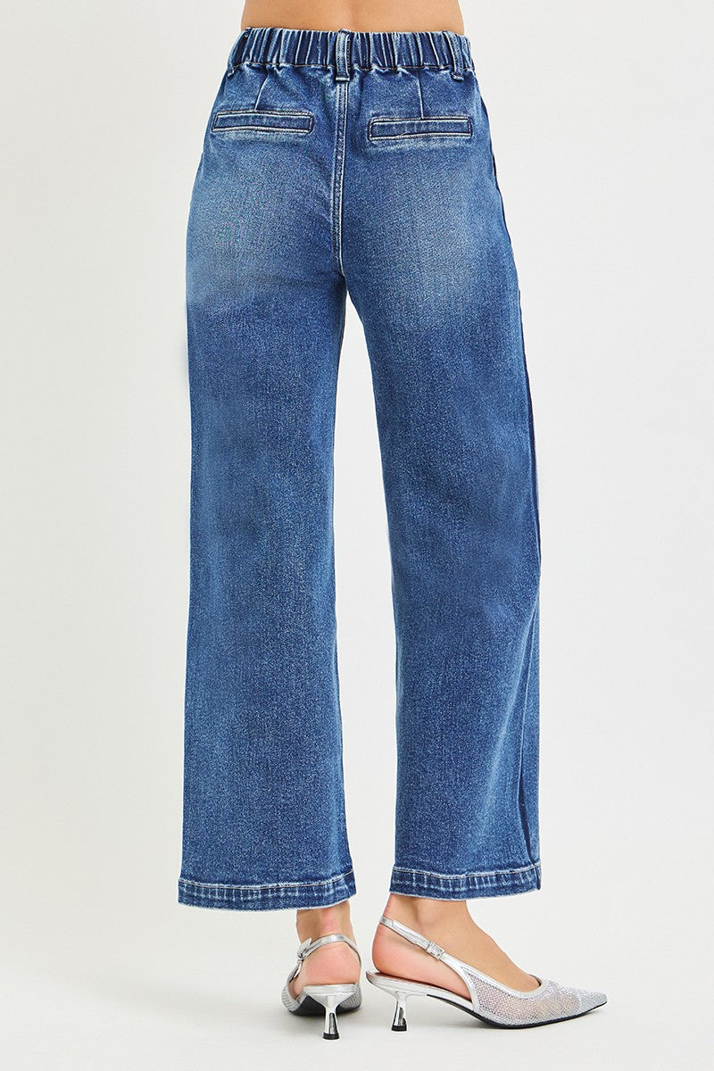 Risen high-rise cropped wide jeans with elastic waistband, showcasing a trendy casual style and relaxed fit.