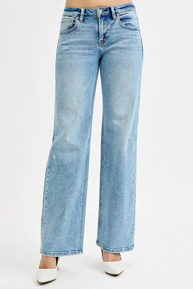 Plus size Risen low-rise ankle boyfriend distressed jeans with a relaxed fit, showcasing faded and ripped details.