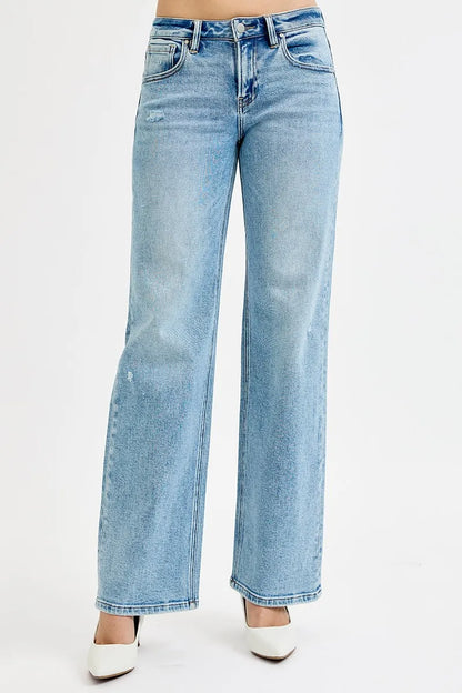 Plus size Risen low-rise ankle boyfriend distressed jeans with a relaxed fit, showcasing faded and ripped details.
