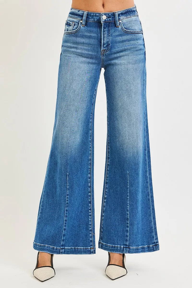 Plus size RISEN mid-rise wide-leg jeans with flared look, casual denim style, shown on a model or laid flat.