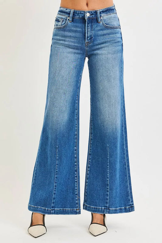 Plus size RISEN mid-rise wide-leg jeans with flared look, casual denim style, shown on a model or laid flat.