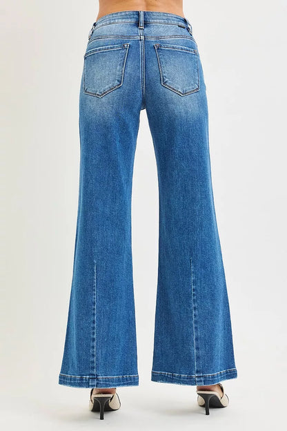 Plus size RISEN full size mid-rise wide-leg jeans with flared look, shown on a model, by Trendsi.