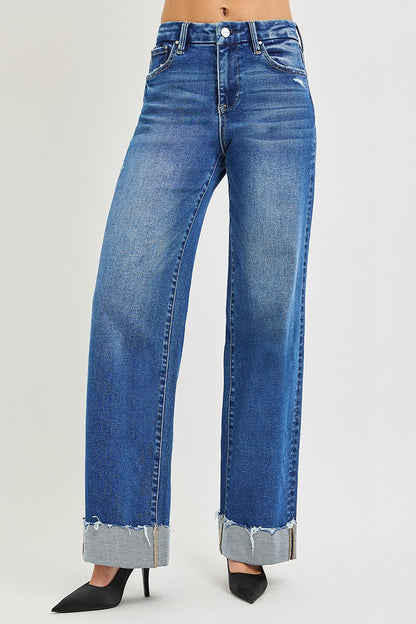 Risen high-rise wide-leg jeans with cuffed hem, denim fabric, and trendy relaxed fit, displayed on a model.