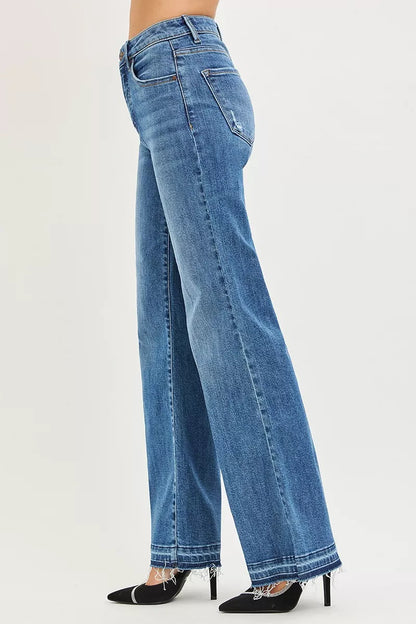 Risen high-rise wide-leg jeans with released hem showing denim fabric and relaxed fit, styled for casual wear.