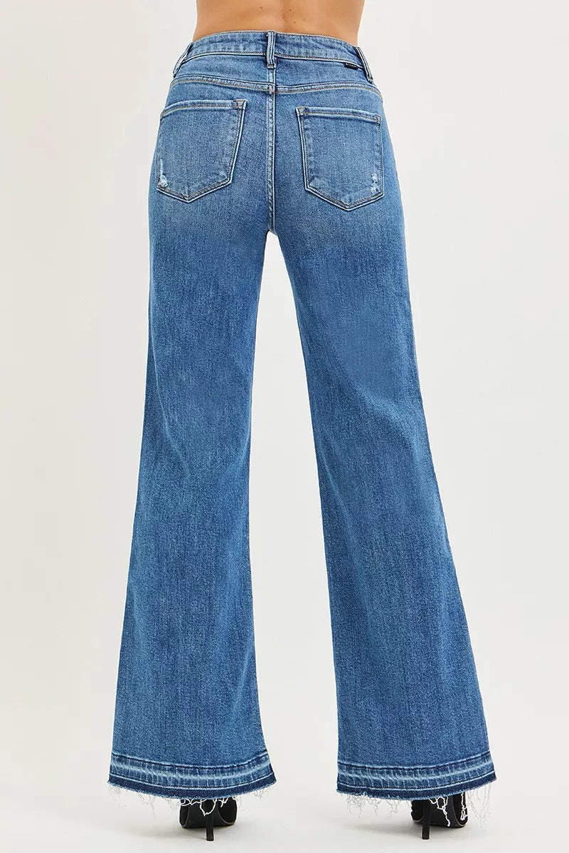 Risen high-rise wide-leg jeans with a released hem, showing the denim fabric and relaxed fit style.