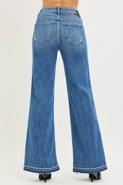 Risen high-rise wide-leg jeans with a released hem, showing the denim fabric and relaxed fit style.