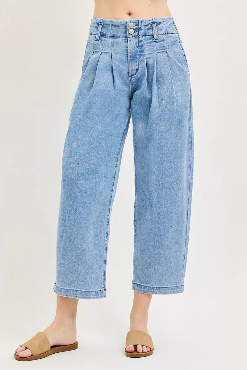 Risen slouchy crop barrel pleated jeans with relaxed fit and pleated detailing, styled for casual wear.