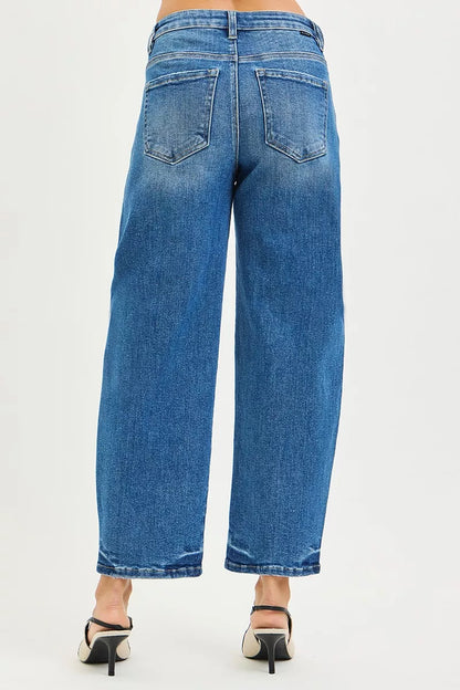 Light blue RISEN slouchy cropped barrel jeans with relaxed fit and rolled cuffs, styled with casual top and sneakers.
