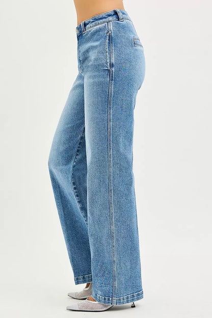 Light blue RISEN Slouchy Straight Jeans by Trendsi with a relaxed fit, shown hanging on a wooden background.