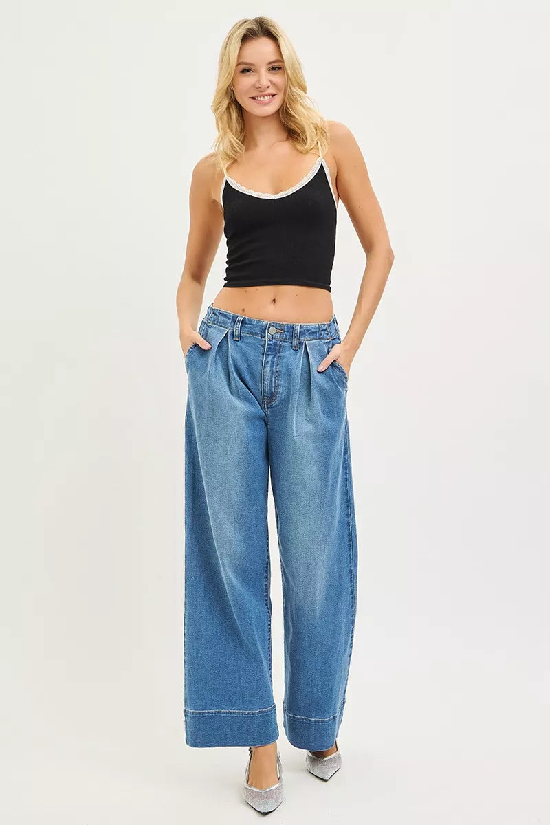 Risen slouchy wide-leg jeans with pleats, showing relaxed fit and stylish design, in a medium wash denim.