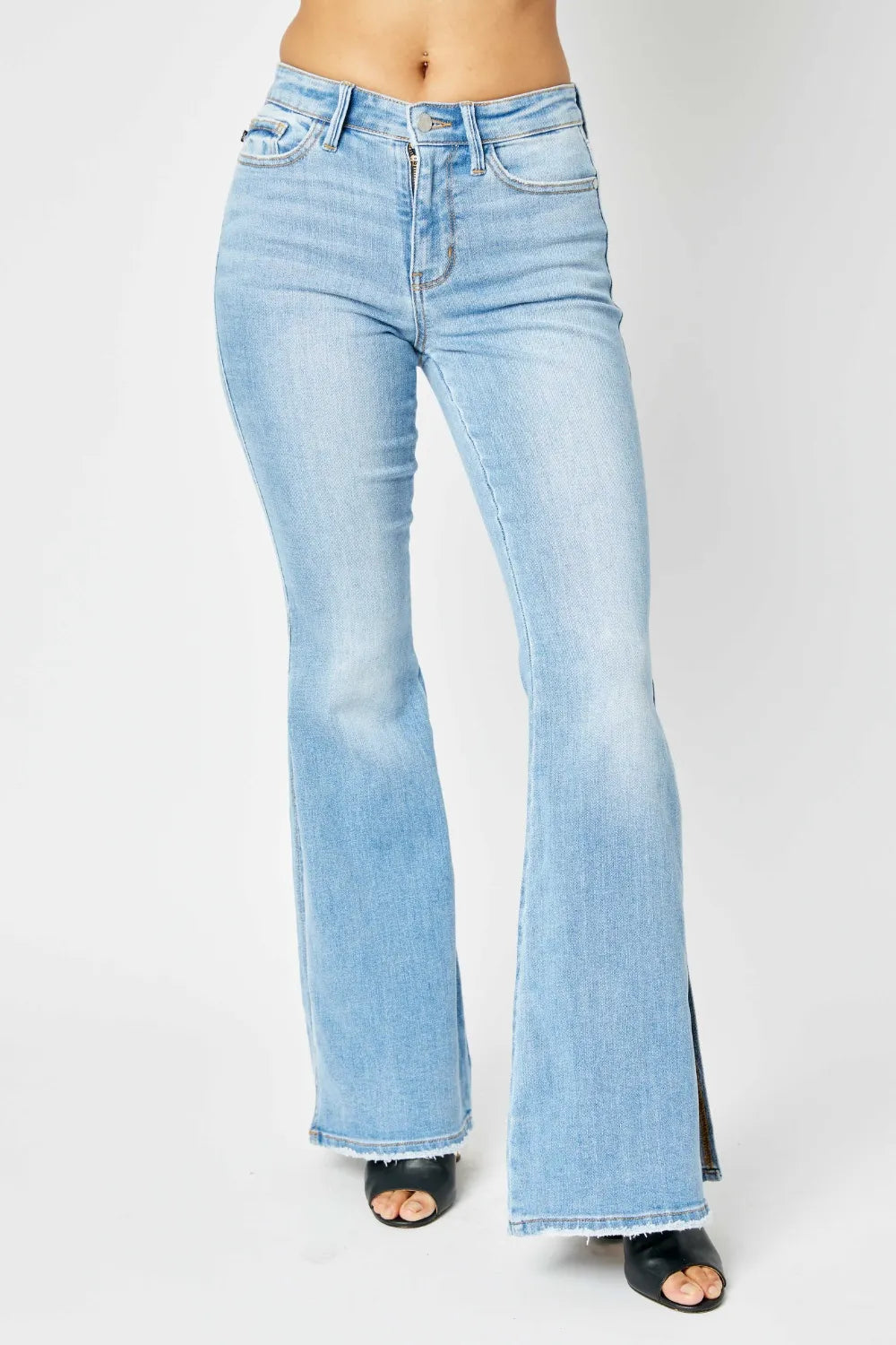 Judy Blue full-size mid-rise raw hem slit flare jeans with distressed details, shown on a model.
