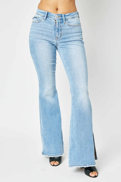 Judy Blue full-size mid-rise raw hem slit flare jeans with distressed details, shown on a model.
