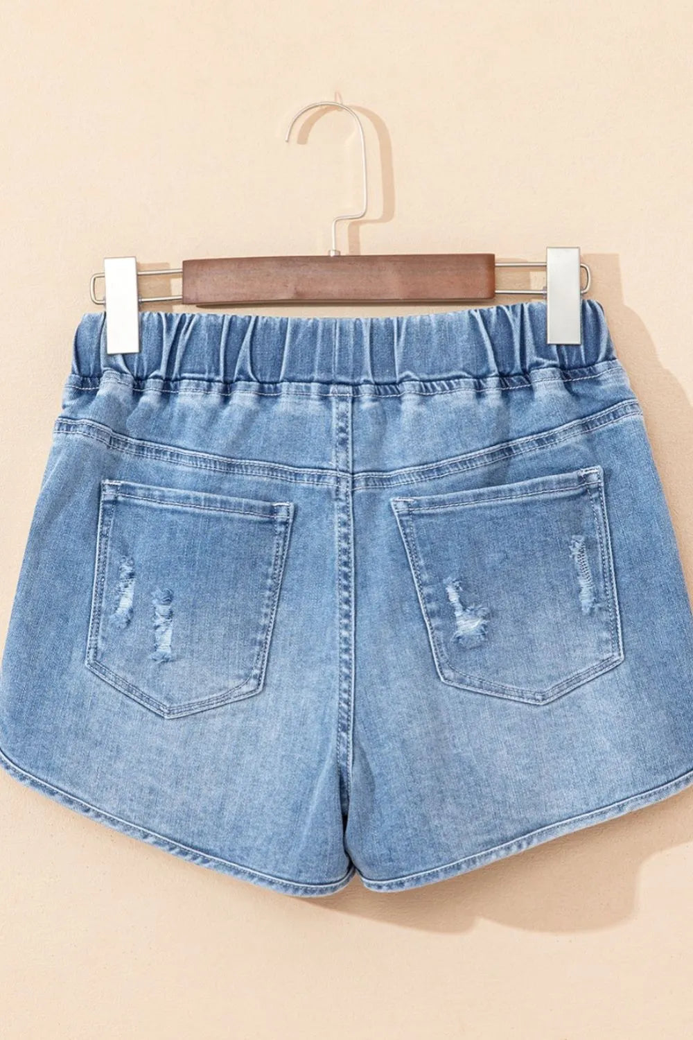 Medium-length distressed denim shorts with drawstring waist from Trendsi, featuring high waist and casual, trendy style.