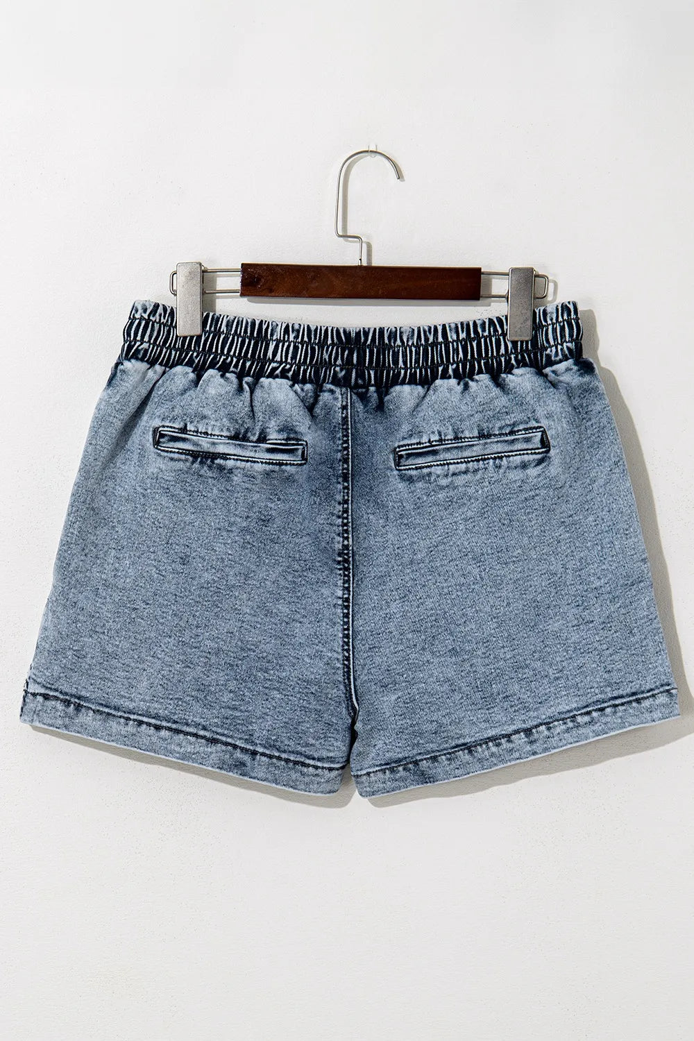 Drawstring high waist denim shorts with pockets, featured by Trendsi, showcasing a casual, stylish look with a relaxed fit.