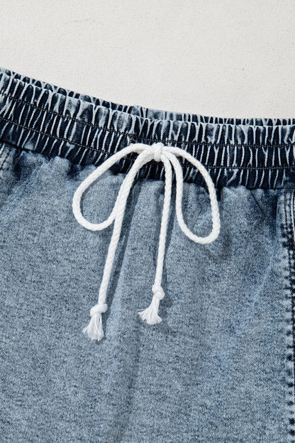 Medium-length drawstring high waist denim shorts with front pockets, styled for casual wear by Trendsi.