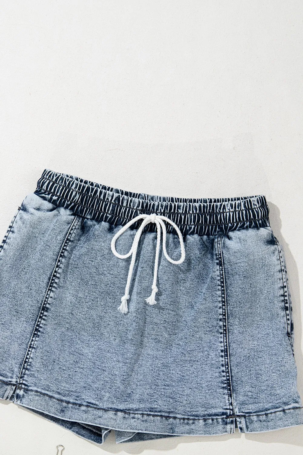 Drawstring high-waist denim shorts with pockets, styled by Trendsi, featuring a casual design and comfortable fit.