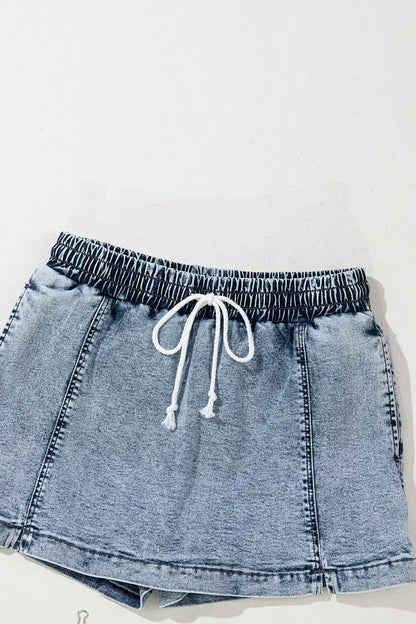 Drawstring high-waist denim shorts with pockets, styled by Trendsi, featuring a casual design and comfortable fit.