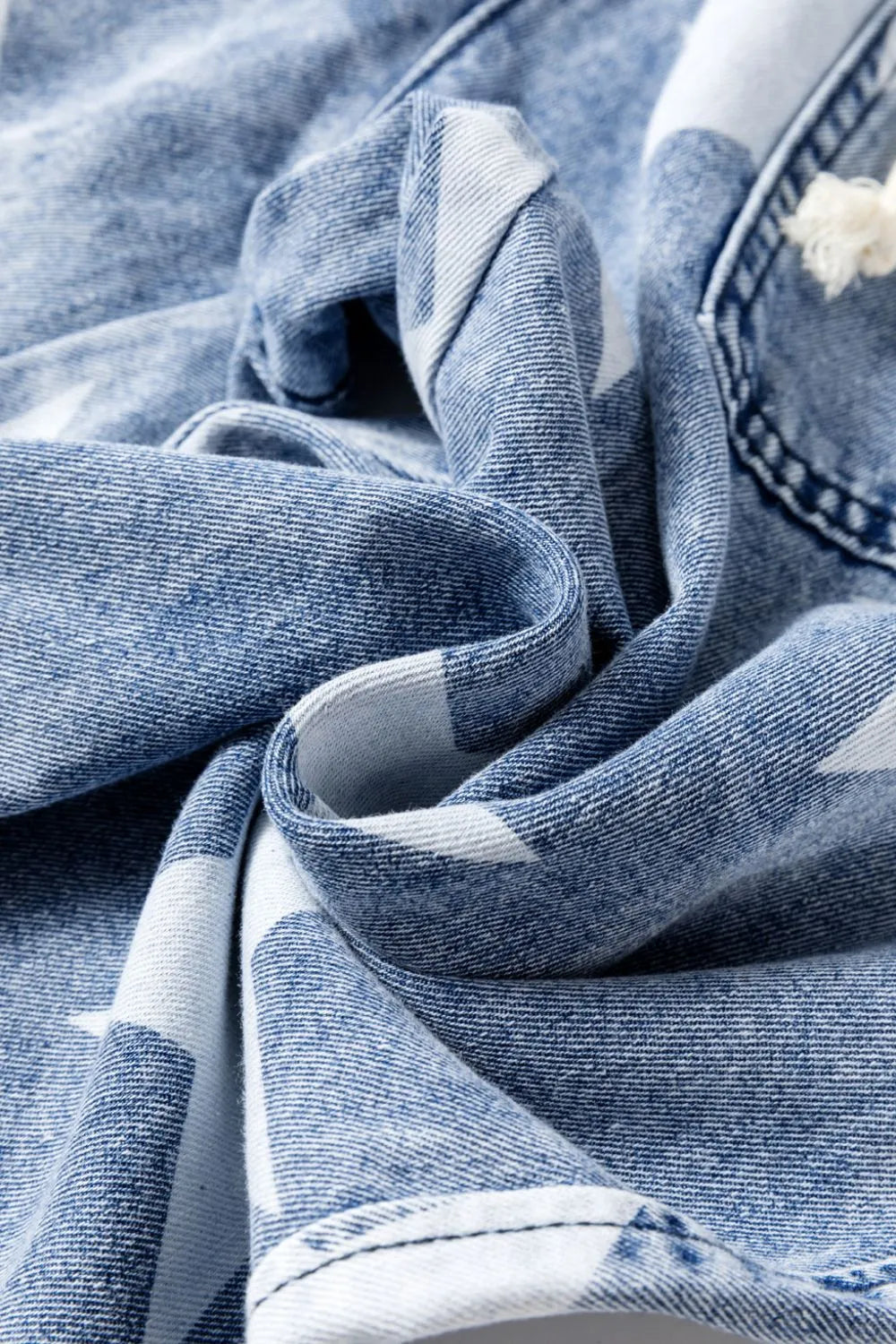 Light blue washed high waist wide-leg jeans with star print and drawstring detail, featuring a casual, relaxed fit.