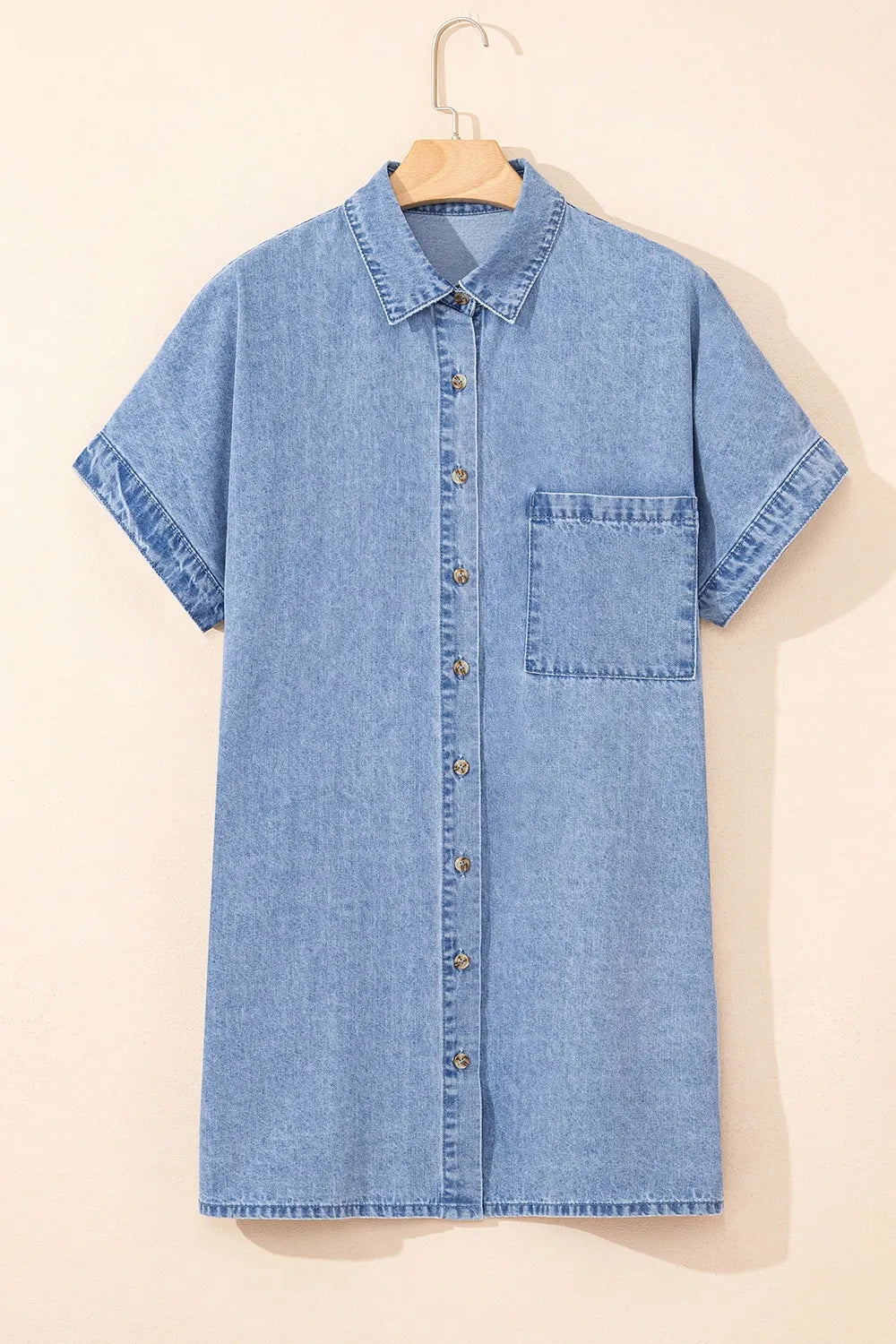 Medium-length button-down short sleeve denim dress by Trendsi, featuring a classic denim fabric and relaxed fit.