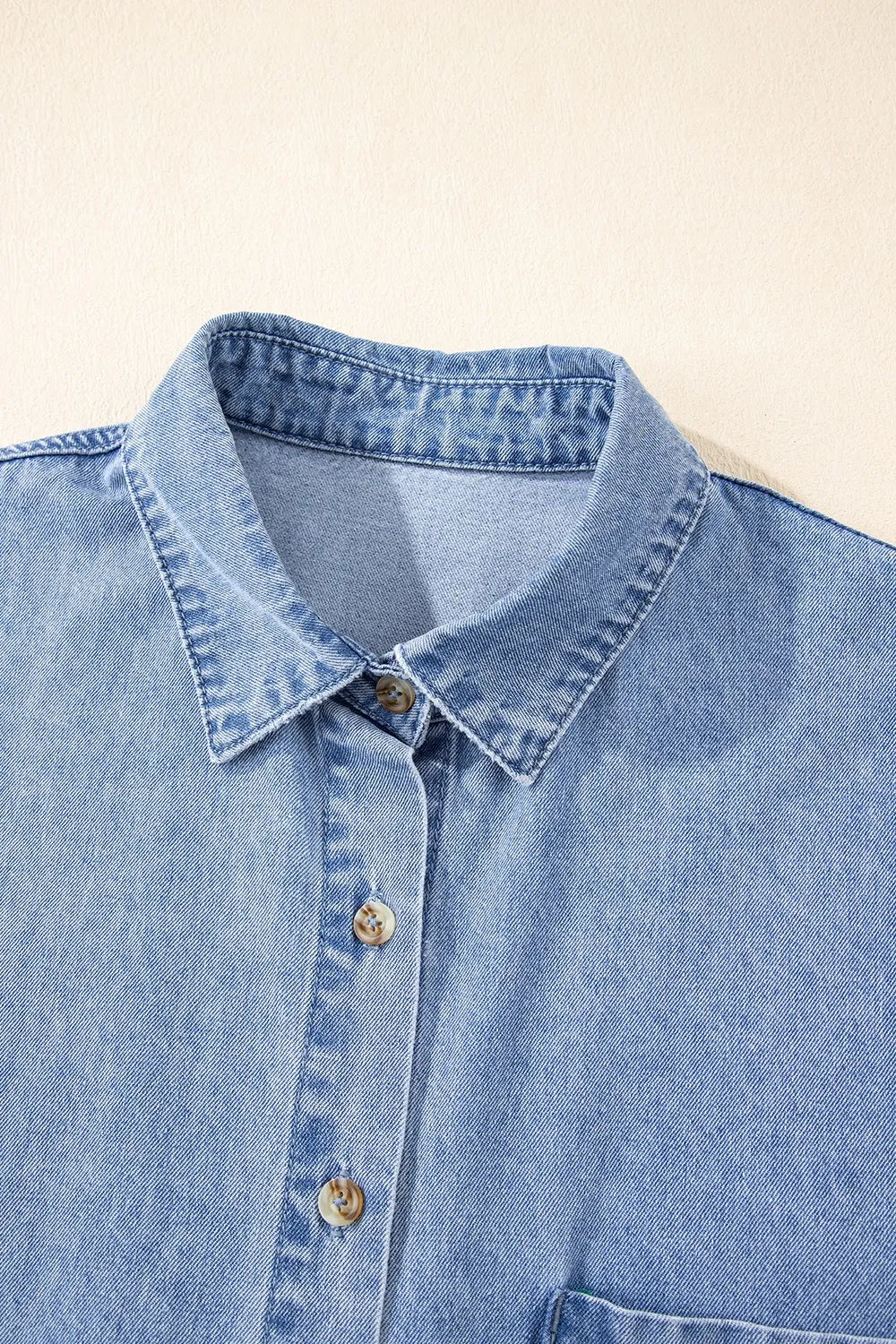 Medium-length button down short sleeve denim dress by Trendsi, featuring classic denim fabric and a stylish casual fit.
