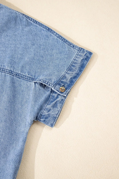 Medium-length denim dress by Trendsi featuring a button-down front and short sleeves, styled for casual wear.