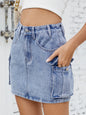 Medium-length denim cargo skirt by Trendsi featuring multiple pockets and a relaxed fit, styled with casual footwear.