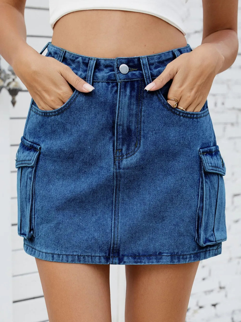 Medium-length trendy cargo denim skirt by Trendsi, featuring multiple pockets and classic blue denim fabric.