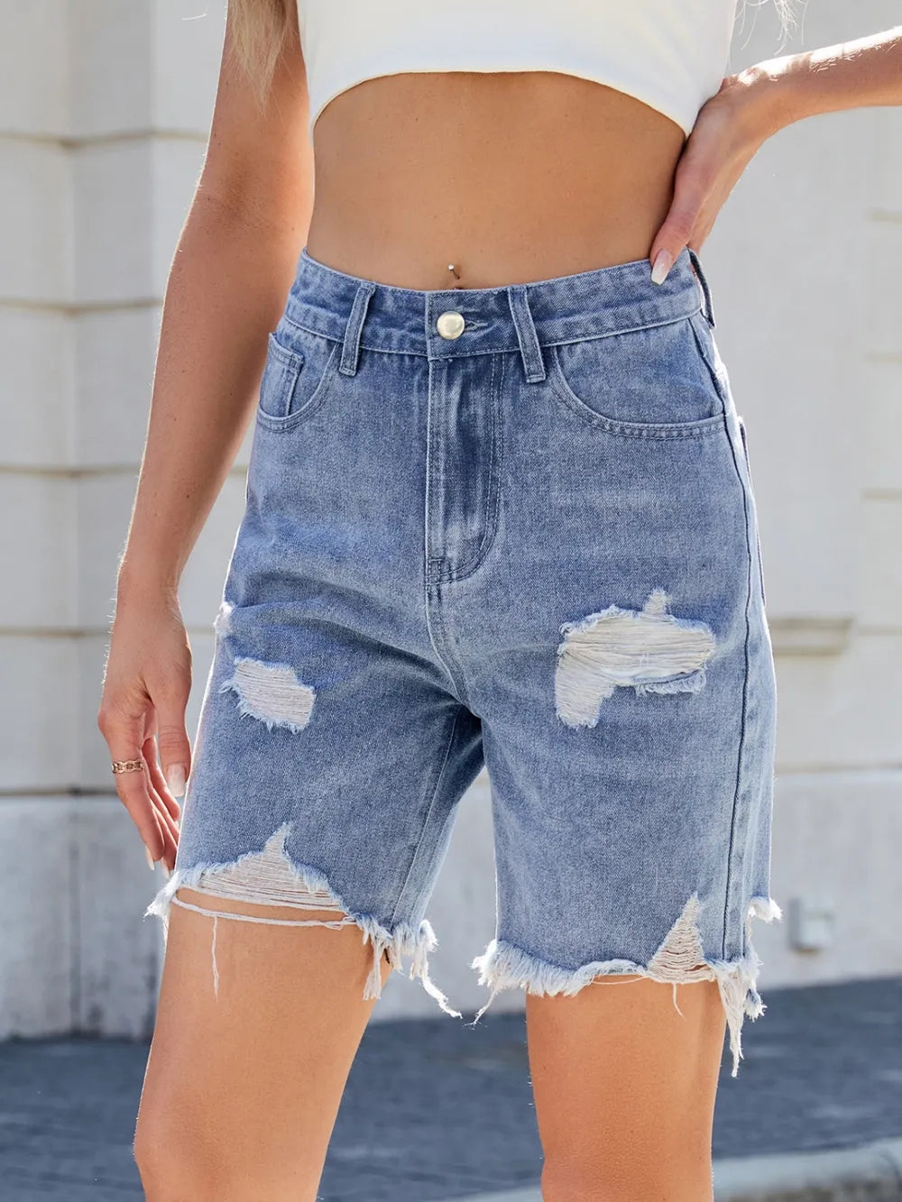 Medium shot of Trendsi distressed raw hem denim shorts with frayed edges and casual fit, showcasing trendy fashion style.