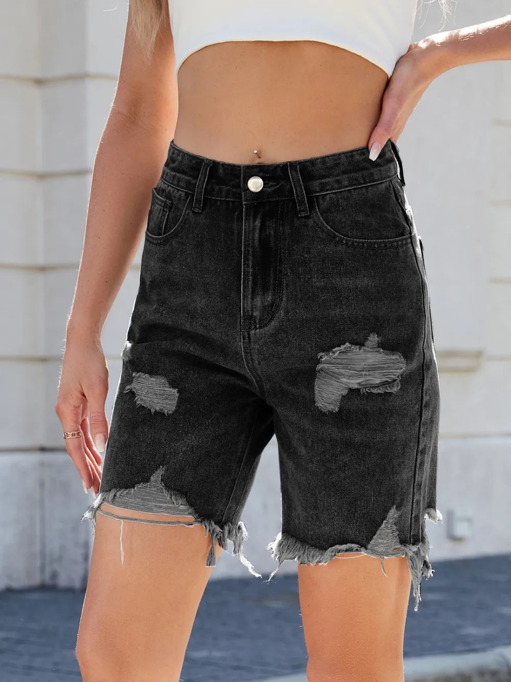 Medium-length distressed raw hem denim shorts from Trendsi featuring a casual fit and frayed edges.
