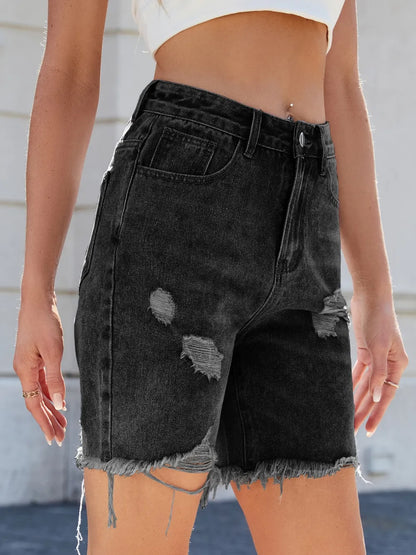 Distressed raw hem denim shorts by Trendsi, featuring frayed edges and casual fit, displayed on a model.