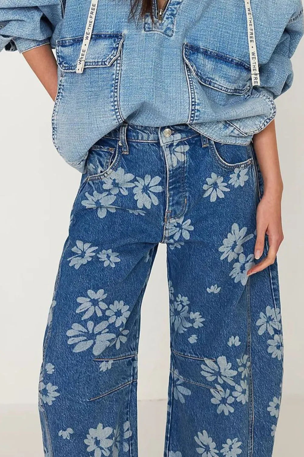 Flower print wide-leg jeans from Trendsi, featuring a high-waist fit, floral pattern, and relaxed wide-leg silhouette.