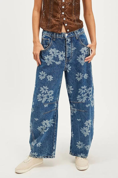Flower print wide-leg jeans from Trendsi featuring a high waist and relaxed fit, with a vibrant floral pattern.