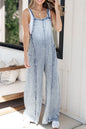 Wide-leg denim overalls with frayed edges and exposed seams from Trendsi, featuring a relaxed fit and casual style.