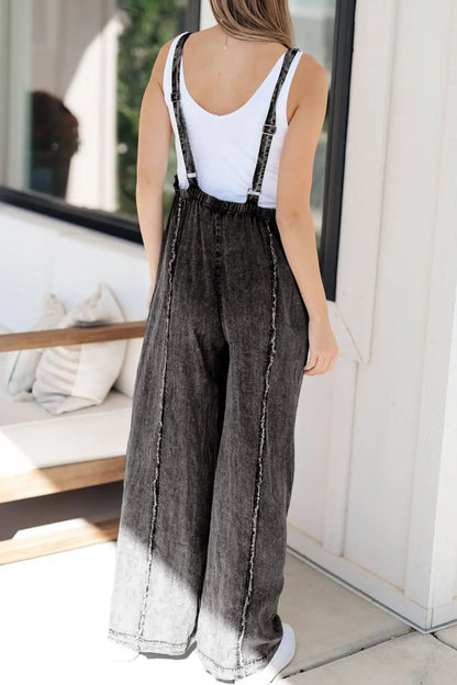 Light blue wide-leg denim overalls with frayed exposed seams and adjustable straps, styled by Trendsi.