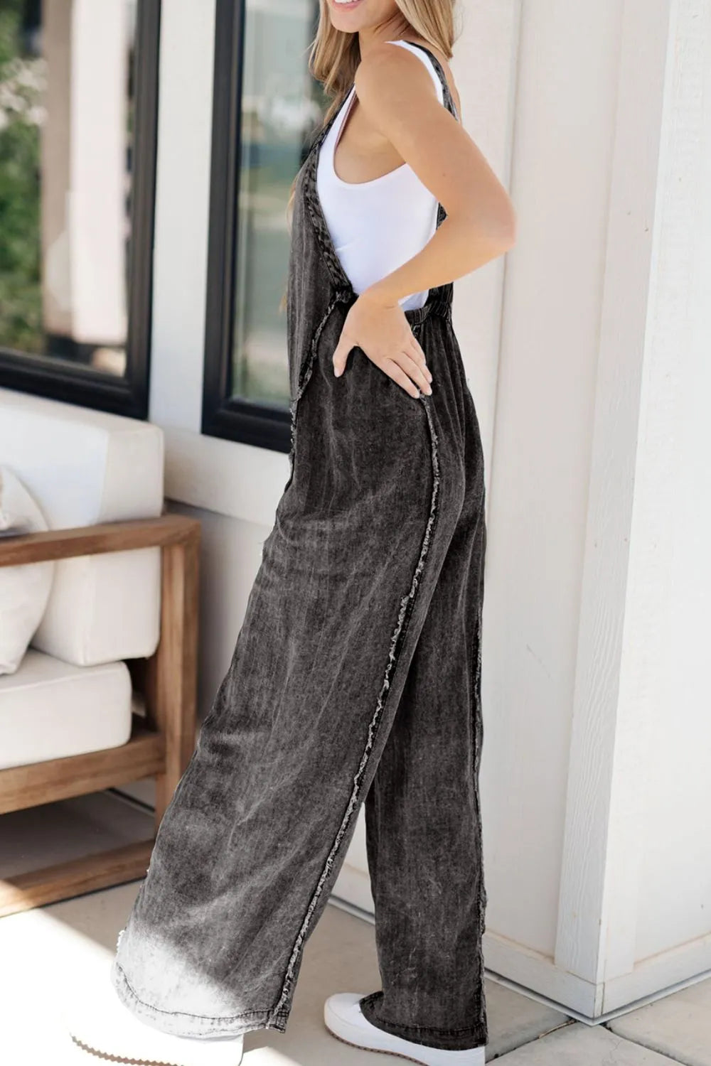 Medium shot of Trendsi frayed exposed seam wide-leg denim overalls with adjustable straps and distressed details.