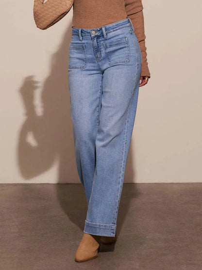 Medium shot of Trendsi high-rise wide-leg jeans with front pockets and patch detailing on a white background