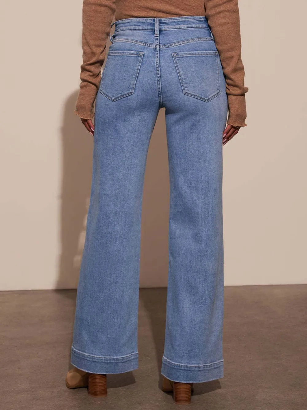 High rise wide-leg jeans with front pockets and patch details from Trendsi, featuring a relaxed fit and classic denim style.