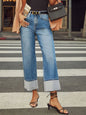 Medium wash high waisted straight leg rolled jeans from Trendsi, featuring classic denim style and a comfortable fit.