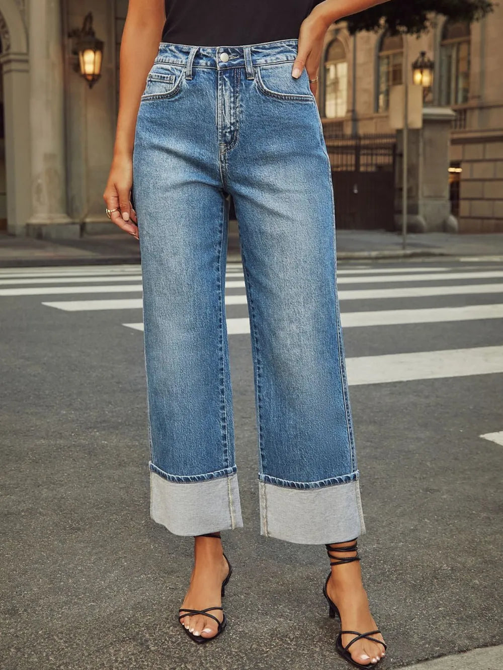 Medium wash high-waisted straight leg rolled jeans by Trendsi, showing fit and cuffed hem style on a mannequin.