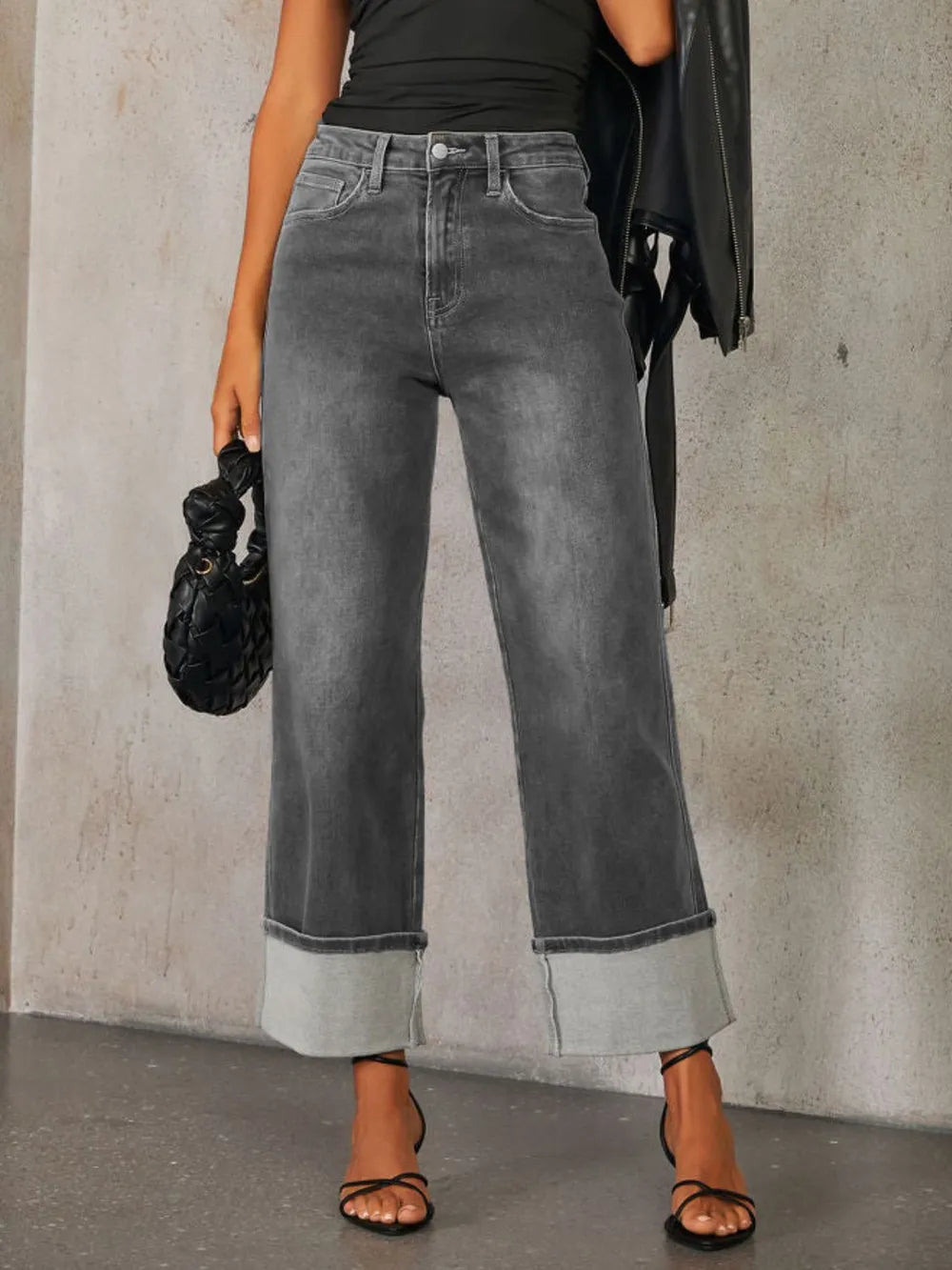 Medium shot of Trendsi high-waisted straight leg rolled jeans hanging on a clothing rack, showing denim texture and rolled cuffs.