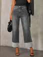 Medium shot of Trendsi high-waisted straight leg rolled jeans hanging on a clothing rack, showing denim texture and rolled cuffs.