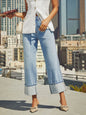 Medium wash high-waisted straight-leg rolled jeans from Trendsi, shown on a model highlighting the fit and style.
