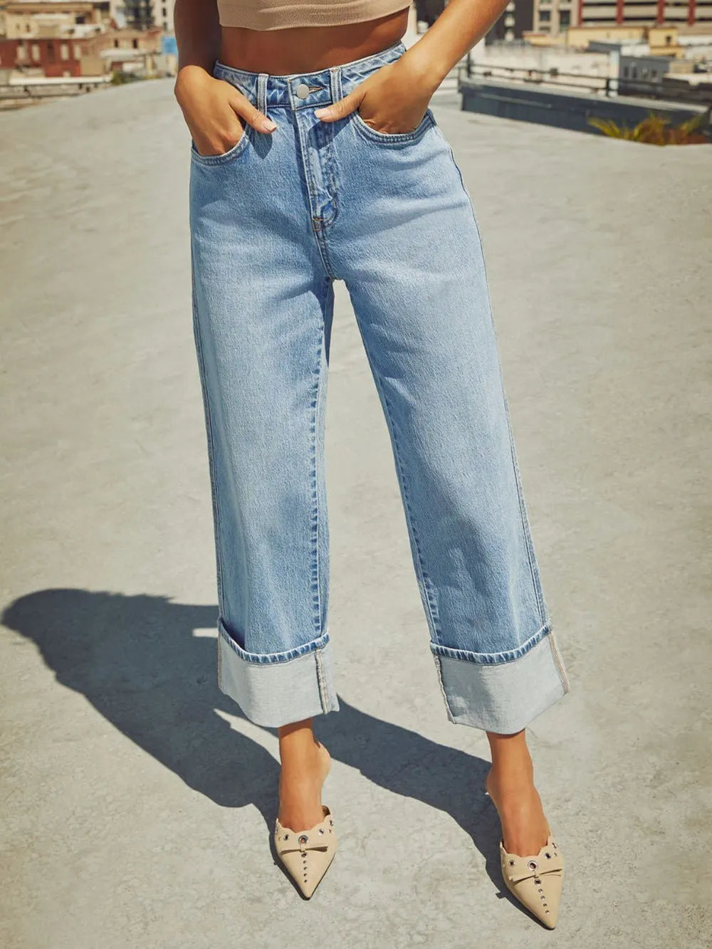 Medium wash high waisted straight leg rolled jeans from Trendsi, showcasing a stylish fit and classic denim design.